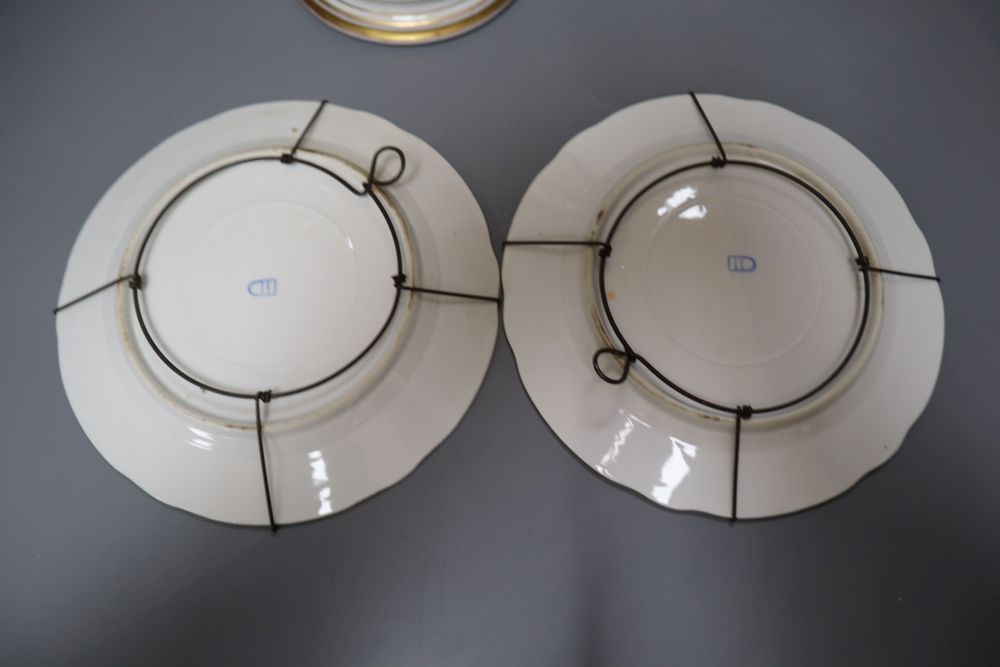 A 19th century French bisque figure, 32cm and two Vienna-style wall plates, 22cm